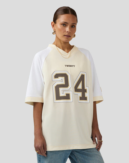 Female model wearing cream and white Twenty 24 football jersey with bold front numbers.