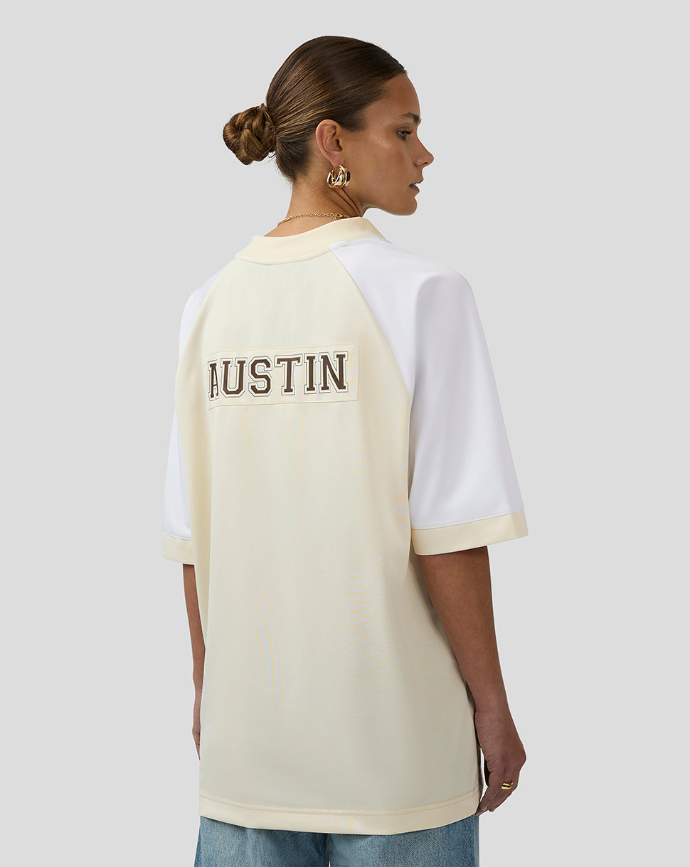 Model wearing cream and white Oracle Red Bull Racing Austin football jersey with AUSTIN across the back