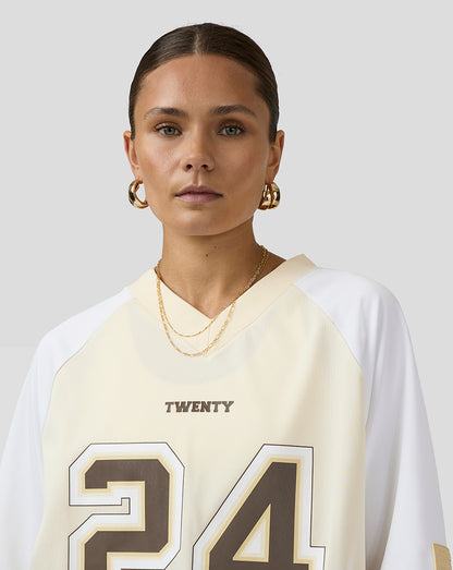 Head and shoulders portrait of a model in a cream and white Austin jersey with AUSTIN on the back.