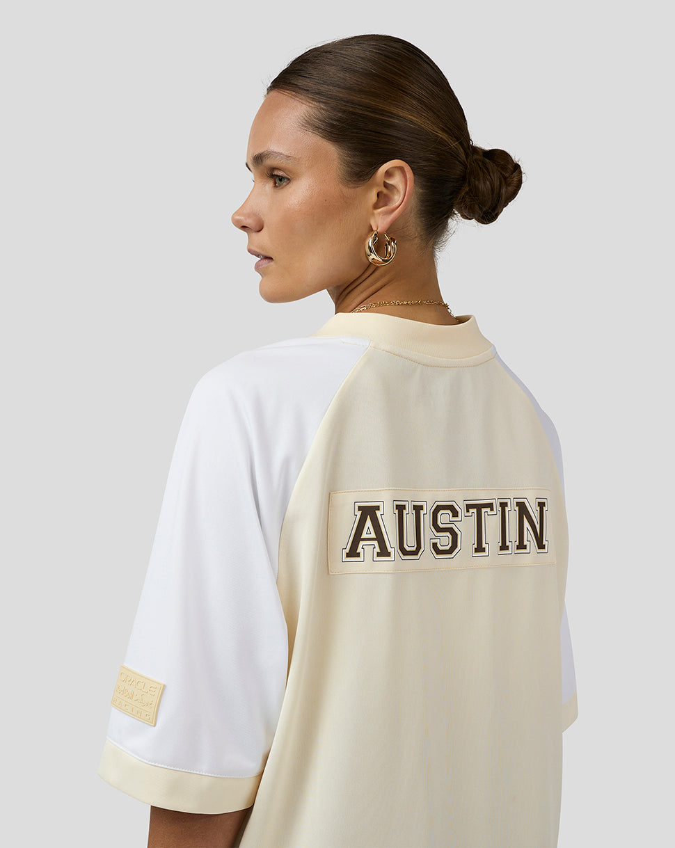 Back view of a model wearing a cream and white Austin football jersey with AUSTIN across the back.