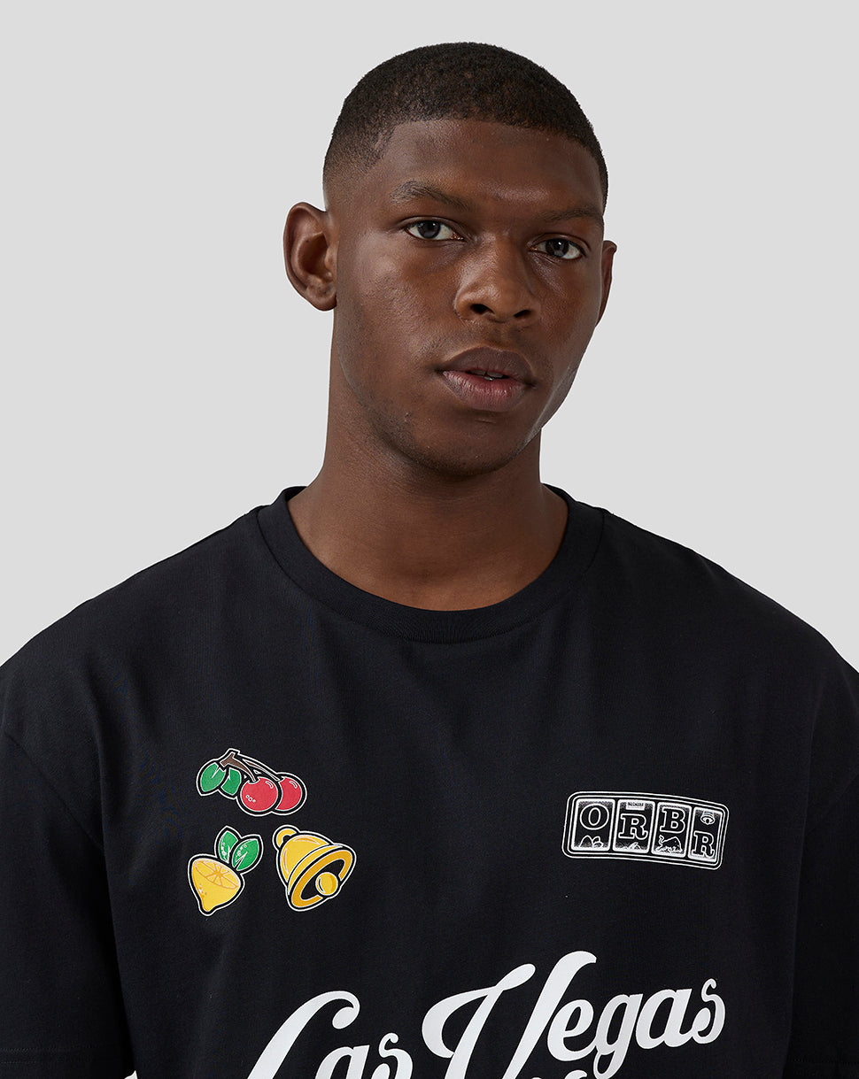 Close up of a black Las Vegas T shirt with colorful fruit graphics and an ORBR patch on the chest.