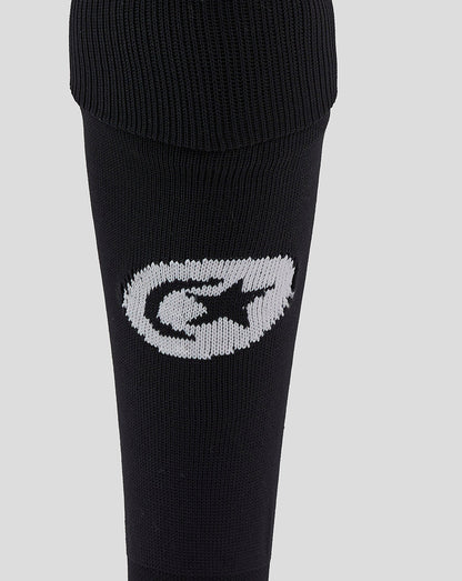Close-up of the black sock showing a white stitched Saracens emblem on the calf area