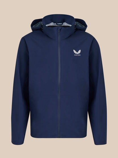 Front view of navy unisex waterproof jacket with hood and Castore logo on the chest