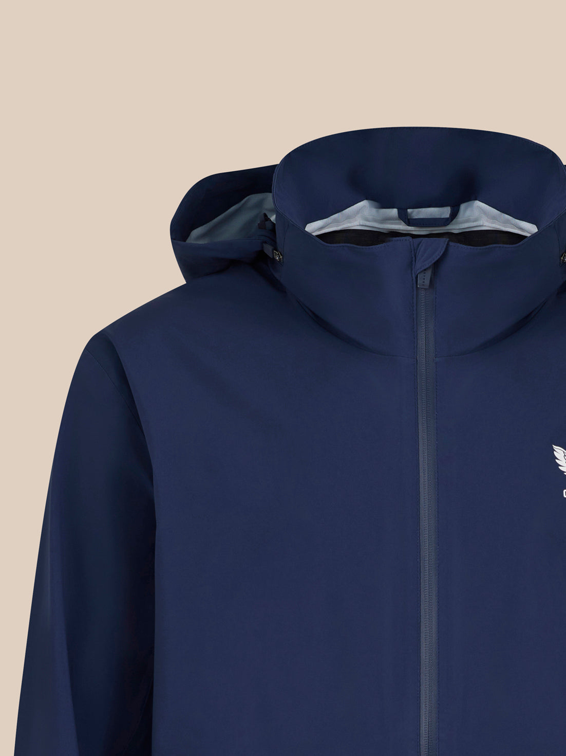 Close-up of navy waterproof jacket hood and zipped front with Castore logo on the chest