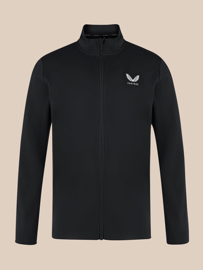 Close up of black unisex softshell jacket with front zipper, high neck collar, and white Castore wing logo on the left chest
