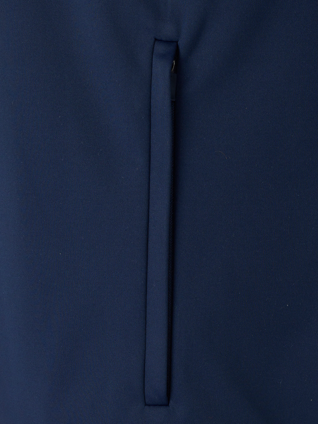 Navy unisex softshell jacket fabric close up with a vertical zip detail