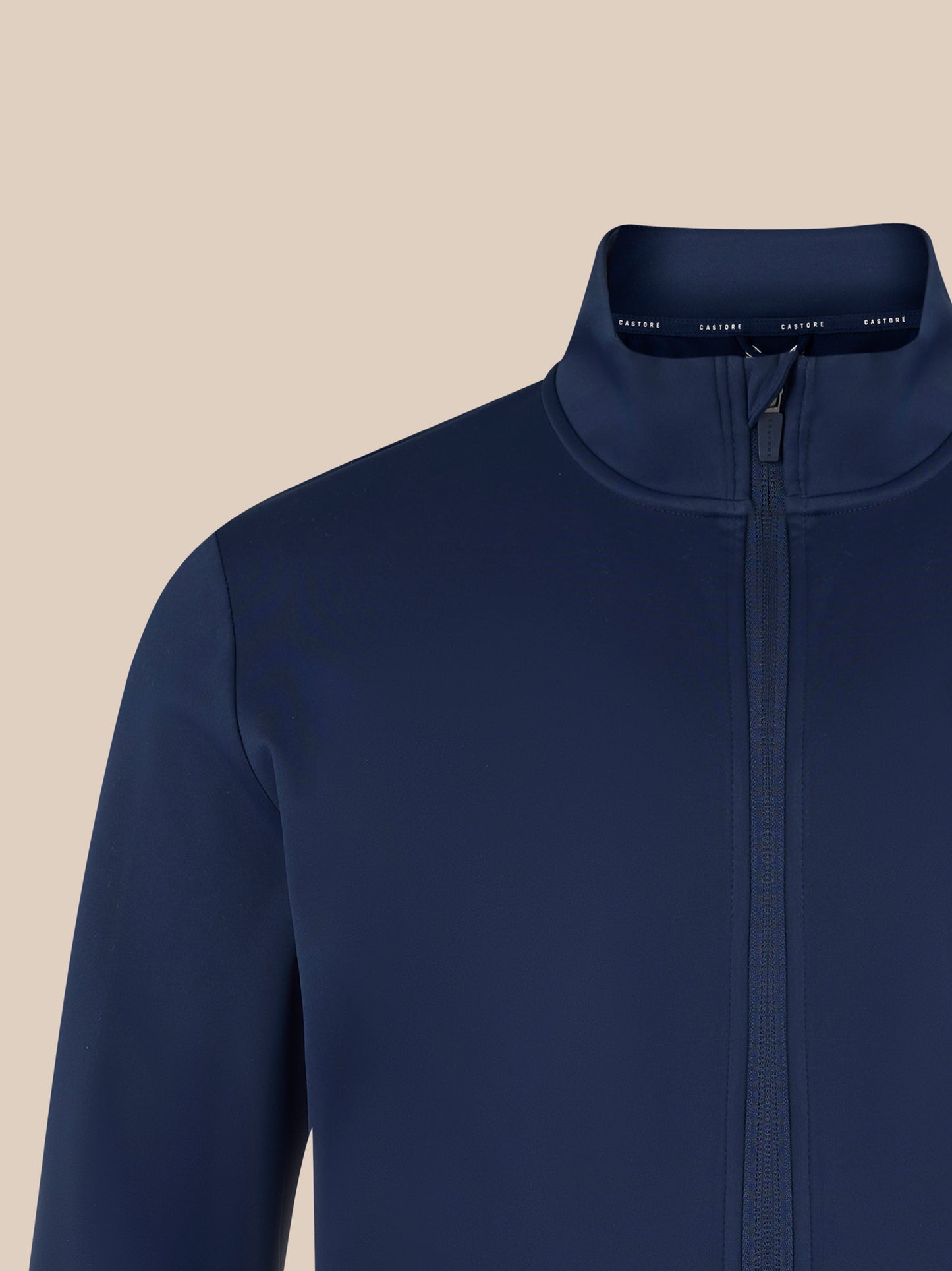 Navy softshell jacket close up of the high collar and zipper with a clean streamlined design.