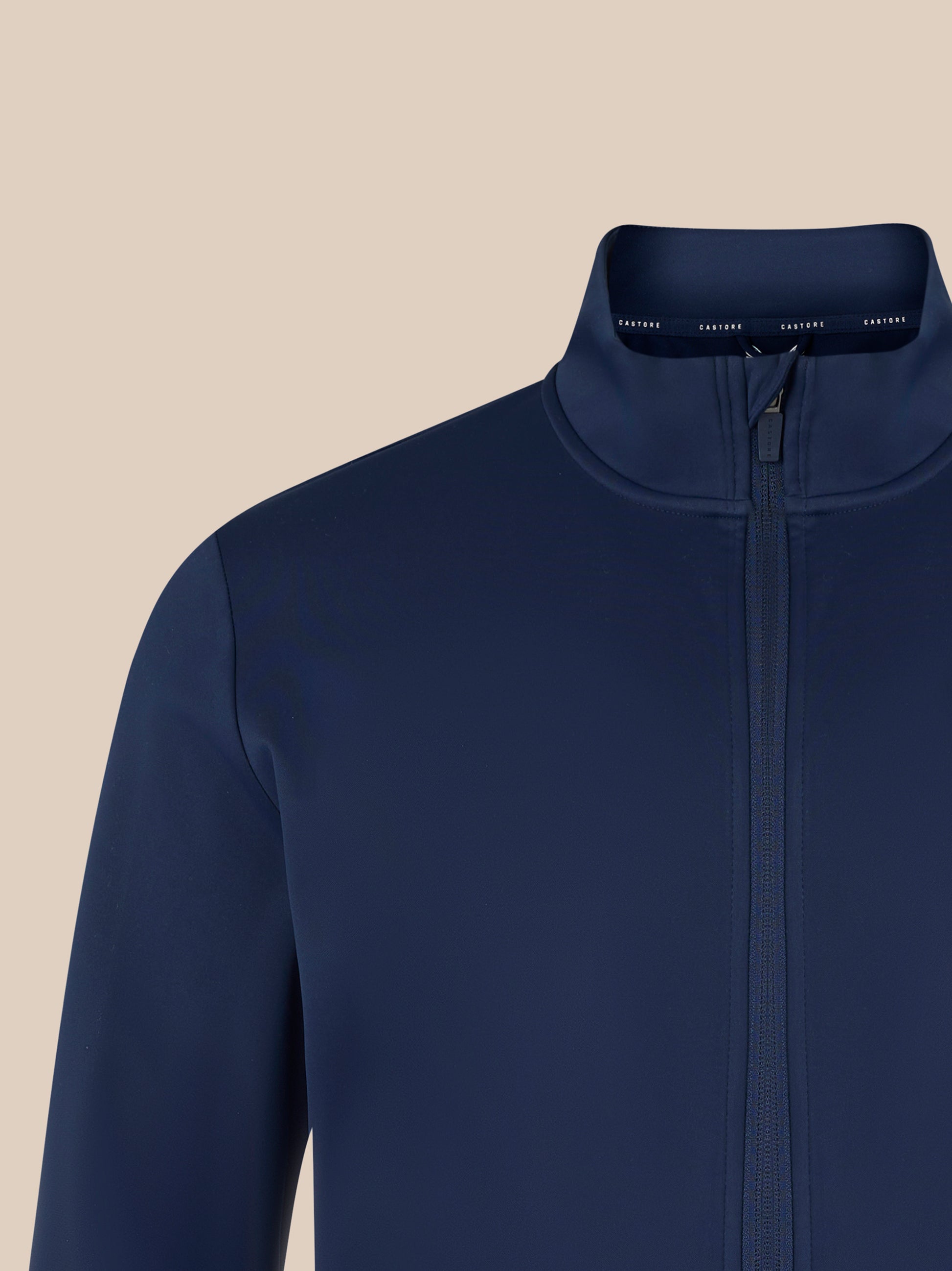 Navy softshell jacket close up of the high collar and zipper with a clean streamlined design.