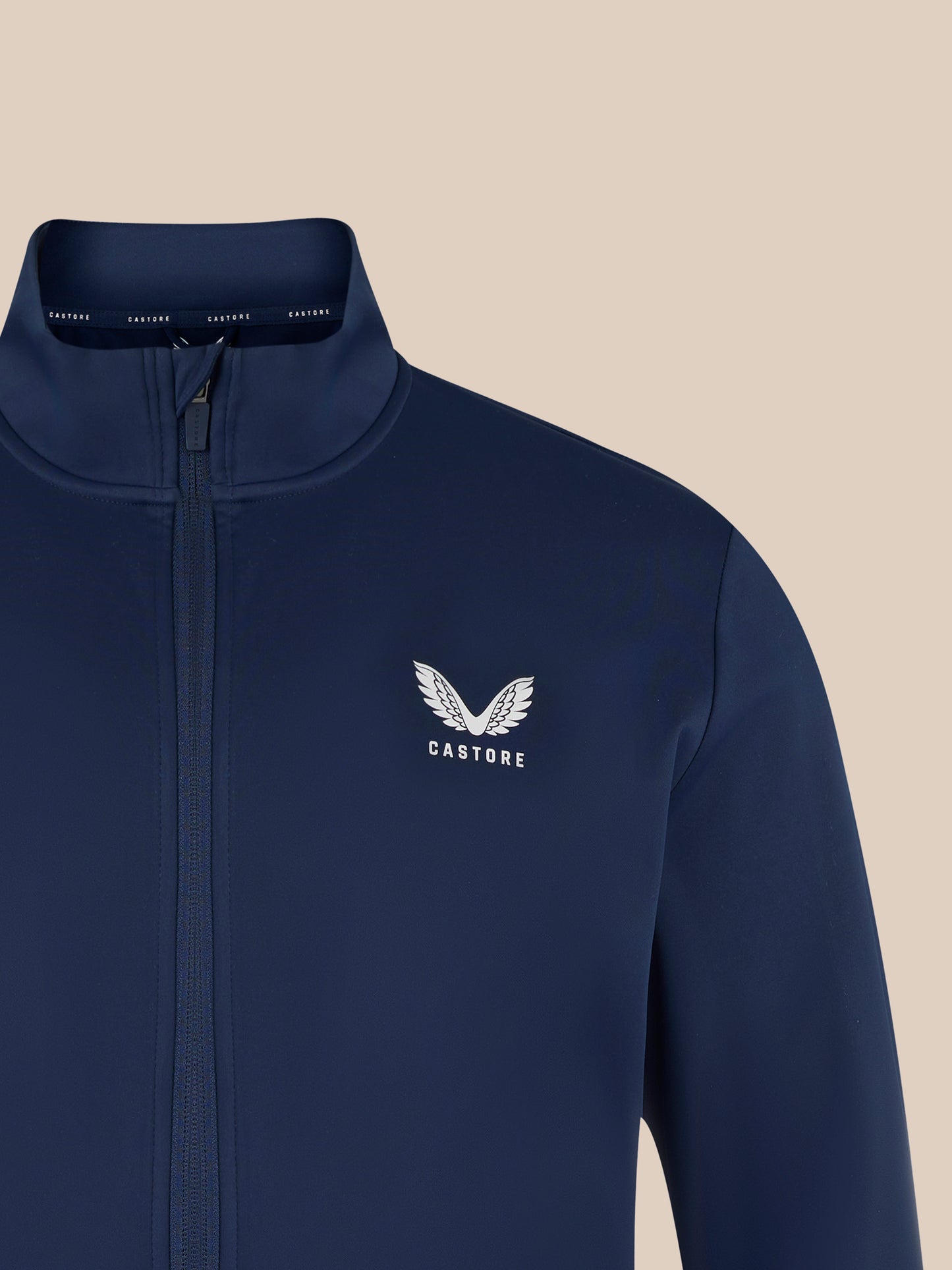 Navy softshell jacket featuring the Castore logo with a white wing emblem on the chest.