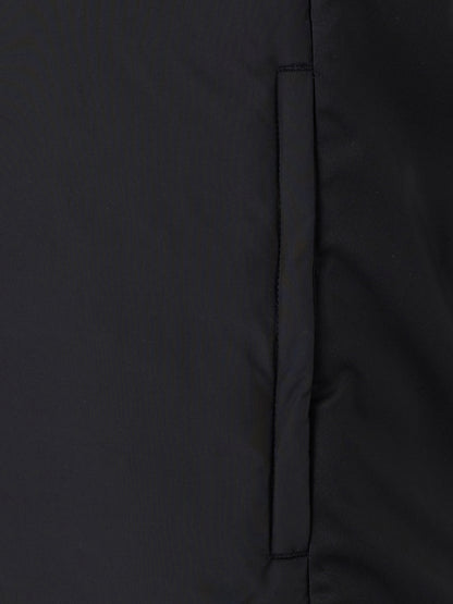 Close-up of the vertical side pocket seam on a black padded gilet