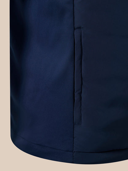 Close-up of navy padded gilet showing vertical zipper along the side
