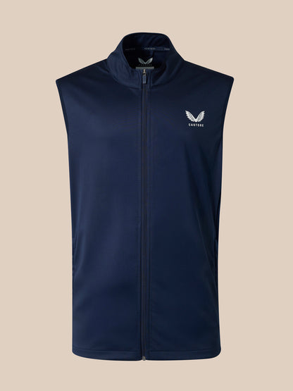 Front view of navy sleeveless softshell gilet with full zipper and small winged emblem on left chest