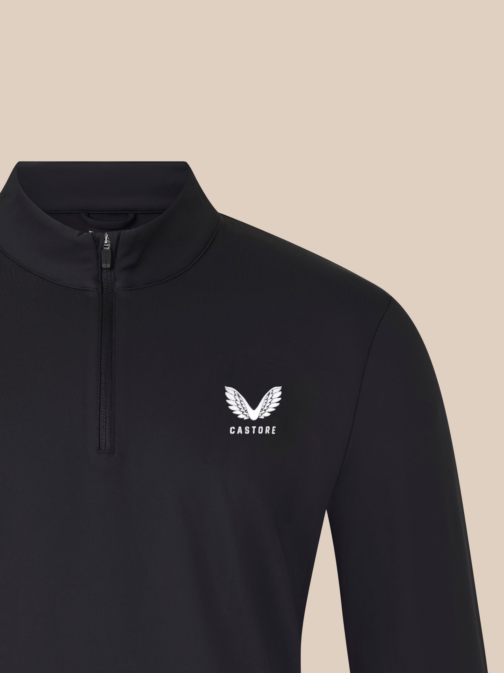 Front view of black 1/4 zip top with a small white winged logo on the left chest and the center zipper.