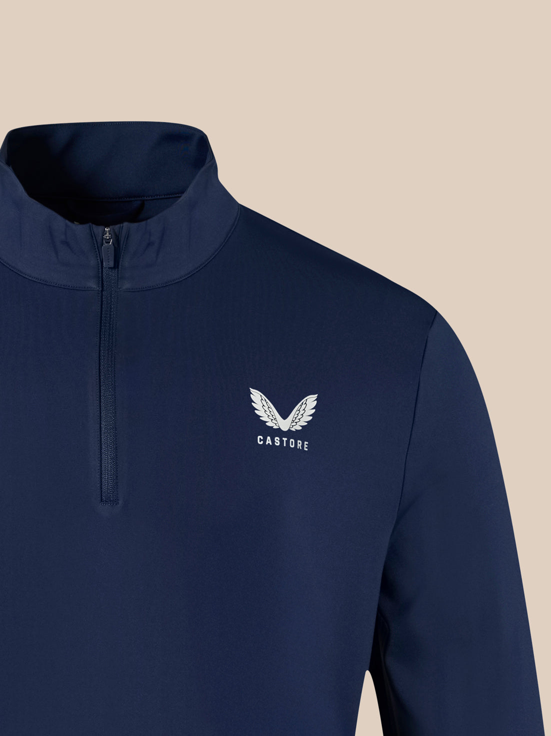 Navy 1/4 zip top with white winged Castore logo on left chest