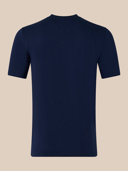 Close-up of navy T-shirt highlighting the white CASTORE logo across the chest and the interior neck label.