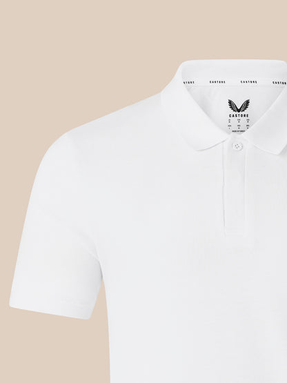Close up of white polo shirt collar with CASTORE logo on the chest