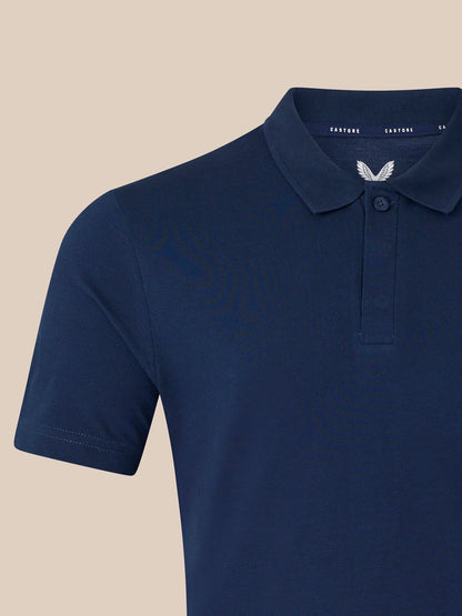 Close-up of navy polo neck collar and placket with left chest logo.