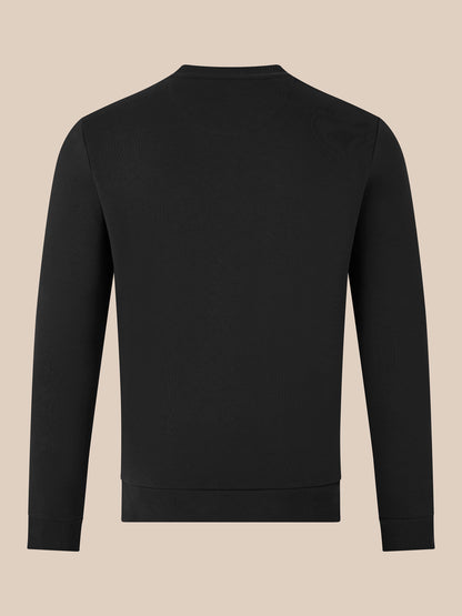 Back view of black crewneck sweatshirt with ribbed cuffs and hem