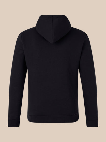 Back view of black hoodie with hood up against a beige background