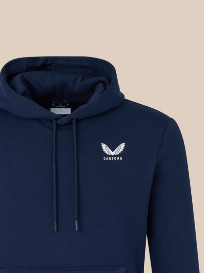 Close up of navy hoodie showing hood with drawstrings and a white wing logo on the chest