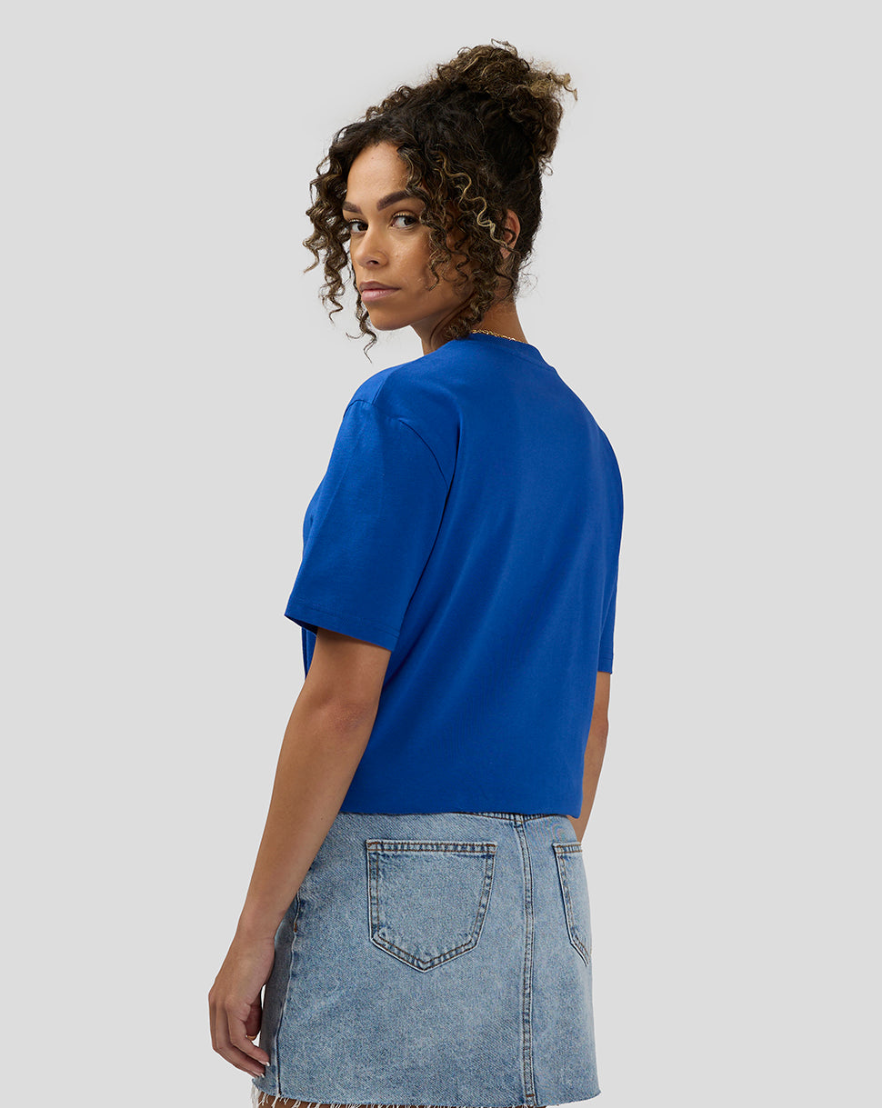 Back view of a model wearing a royal blue Oracle Red Bull Racing 20th anniversary short sleeve T shirt.