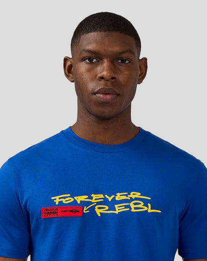 Front view of a male model wearing a blue T shirt with a bold Forever Rebel graphic and red patch on the chest.