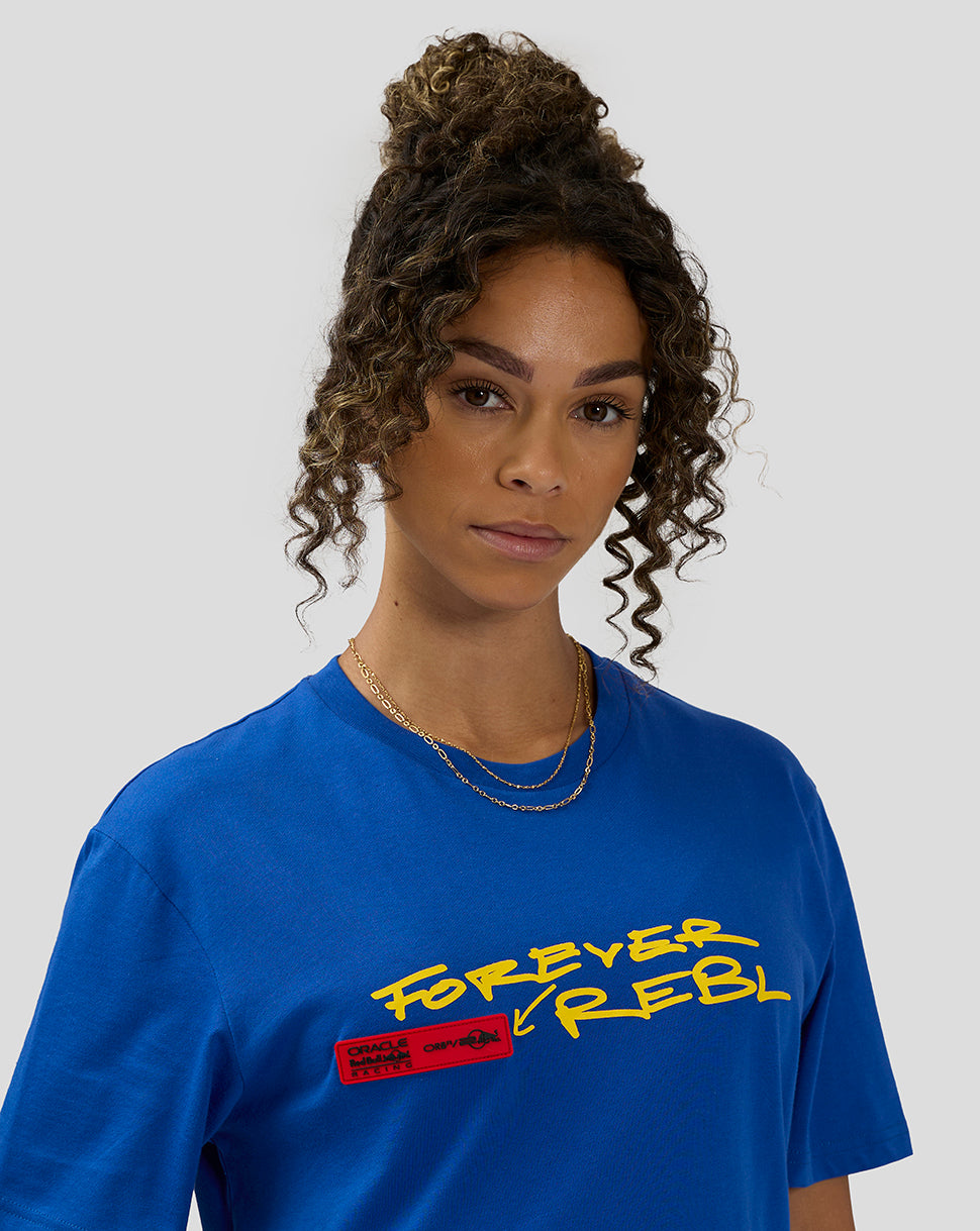 Close-up of a female model wearing royal blue Oracle Red Bull Racing 20th Anniversary T shirt with yellow graphic and red label.