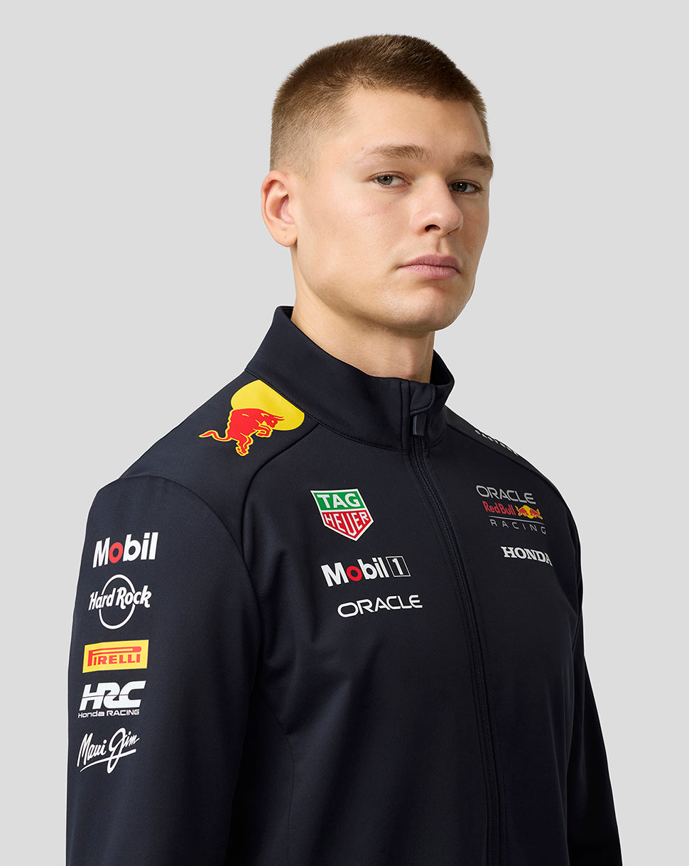 Model wearing navy Night Sky Oracle Red Bull Racing Teamline Soft Shell Jacket with sponsor logos on chest and shoulder