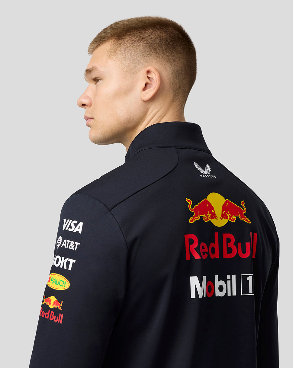 Back view of model in navy Night Sky Teamline Soft Shell Jacket showing Red Bull logo on back and shoulder branding
