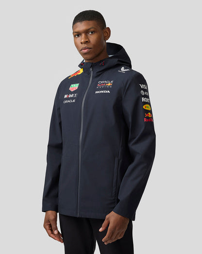 Side front view of navy Night Sky unisex water resistant jacket with hood and sponsor logos on chest and sleeve