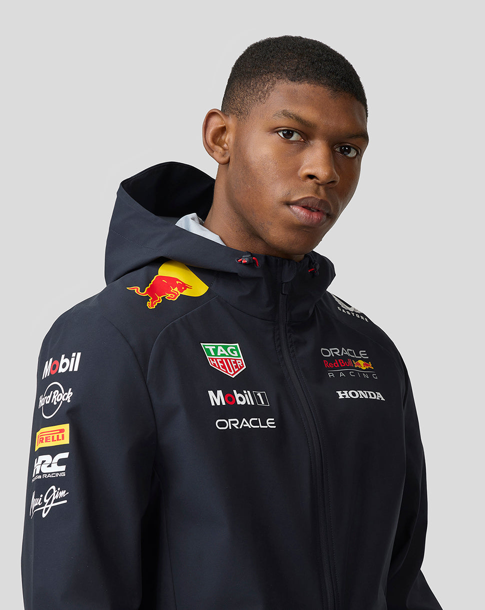 Model wearing navy Oracle Red Bull Racing Teamline jacket with hood and sponsor logos on chest and sleeve