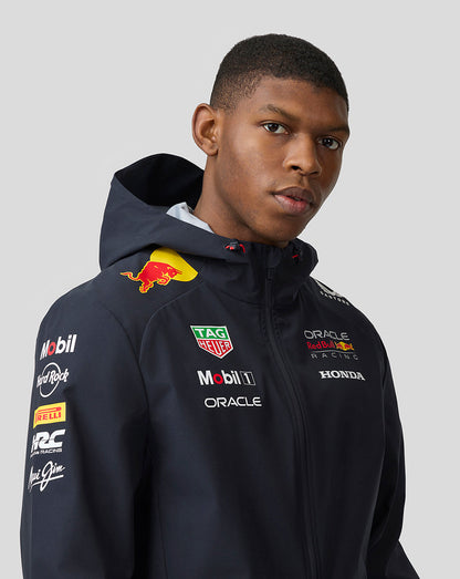 Model wearing navy Oracle Red Bull Racing Teamline jacket with hood and sponsor logos on chest and sleeve