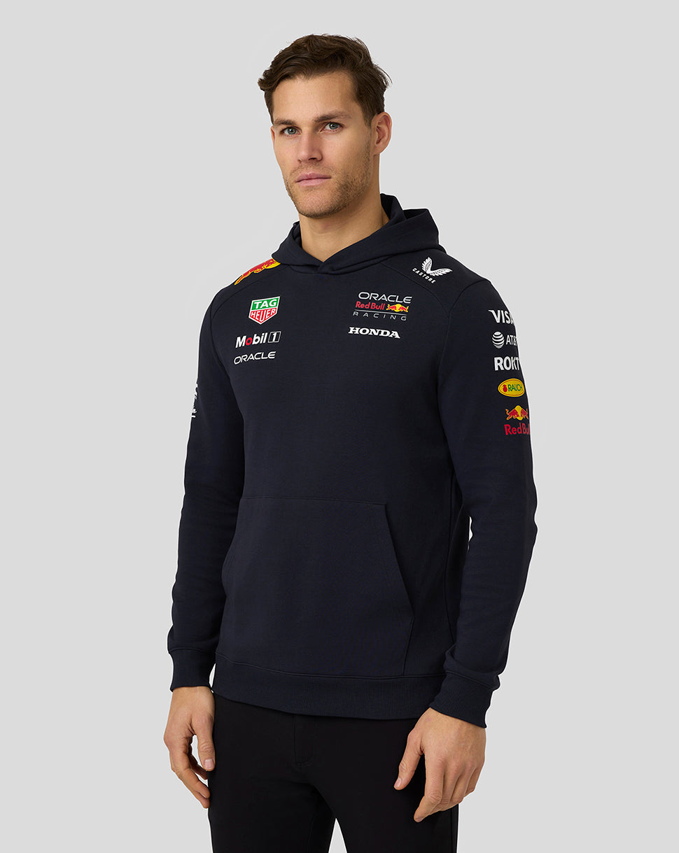 Male model wearing navy night sky Oracle Red Bull Racing Teamline hoodie with sponsor logos on chest and sleeves