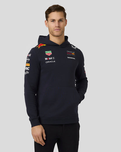 Front view of a man in navy night sky Oracle Red Bull Racing Teamline hoodie showing chest logos and front pocket