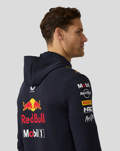Back view of a man in a navy Oracle Red Bull Racing Teamline hoodie with a large Red Bull logo on the back.