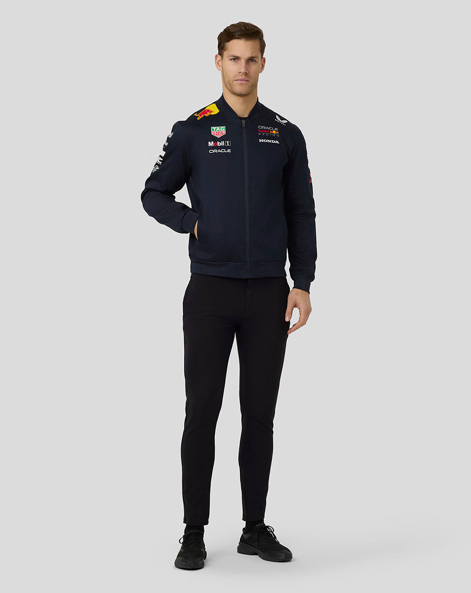 Male model wearing Oracle Red Bull Racing Teamline Bomber Jacket in dark navy with front zip and sponsor logos