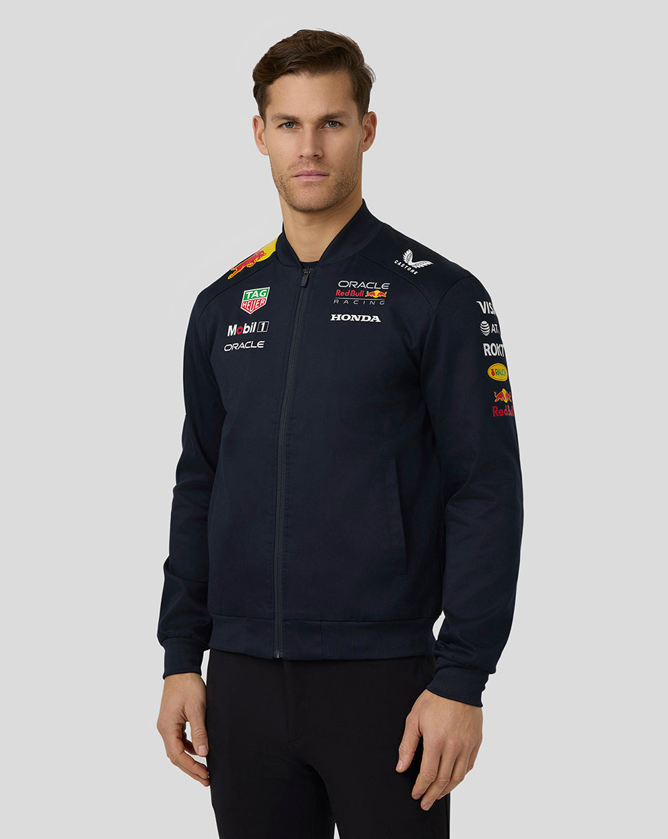 Model wearing navy Red Bull Racing bomber jacket with full front zip and sponsor graphics