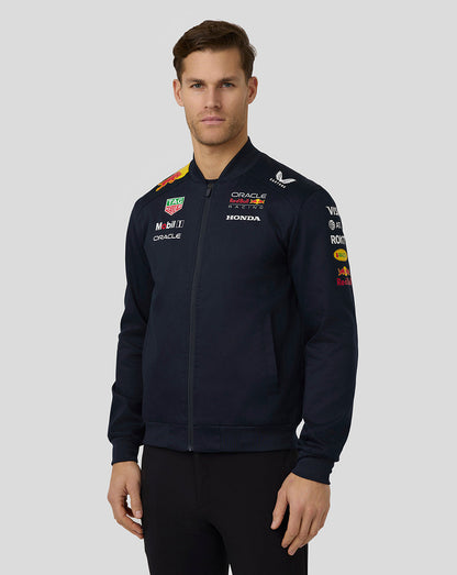 Model wearing navy Red Bull Racing bomber jacket with full front zip and sponsor graphics