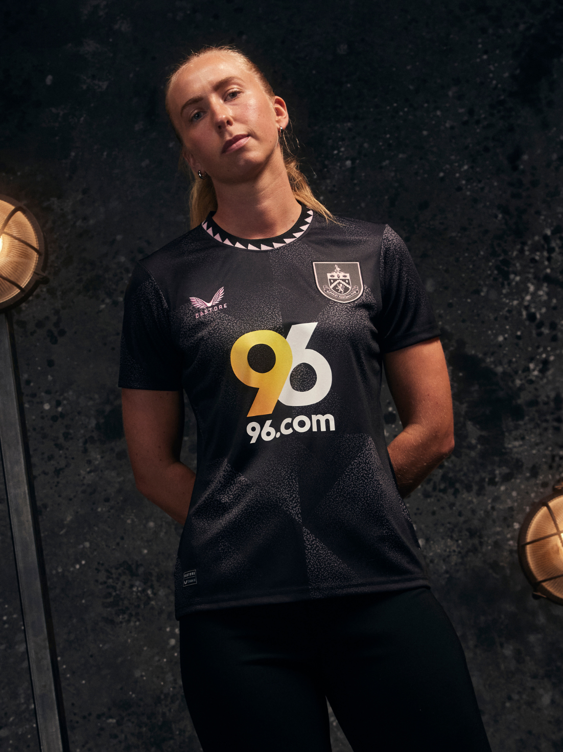 Burnley FC 24/25 women's away shirt in dark navy with light blue sleeves, club crest, and 96.com sponsor.