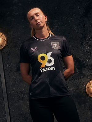 Burnley FC 24/25 women's away shirt in dark navy with light blue sleeves, club crest, and 96.com sponsor.