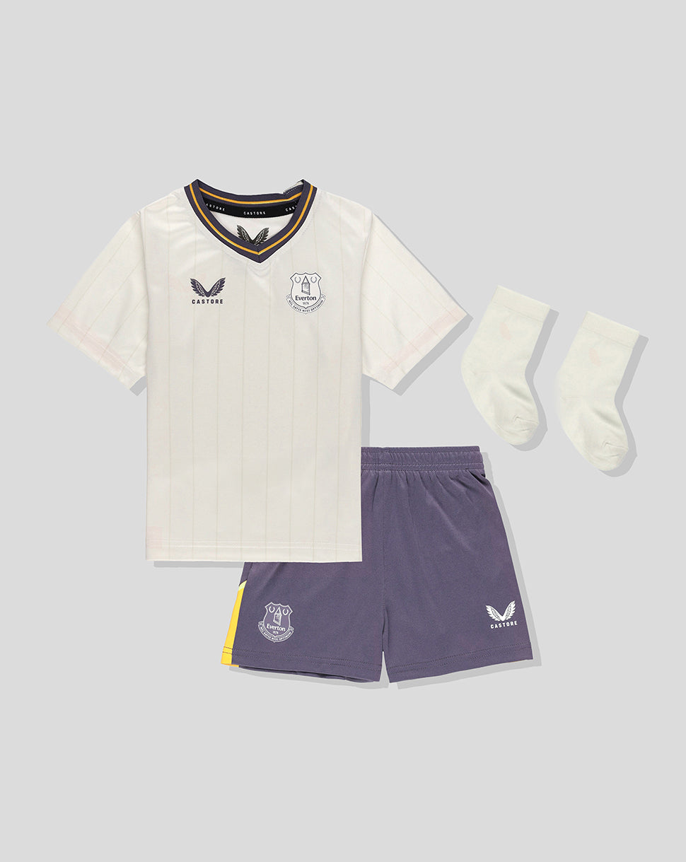 Front view of Everton 24/25 third nested baby kit featuring cream pinstriped jersey, purple shorts, and white socks