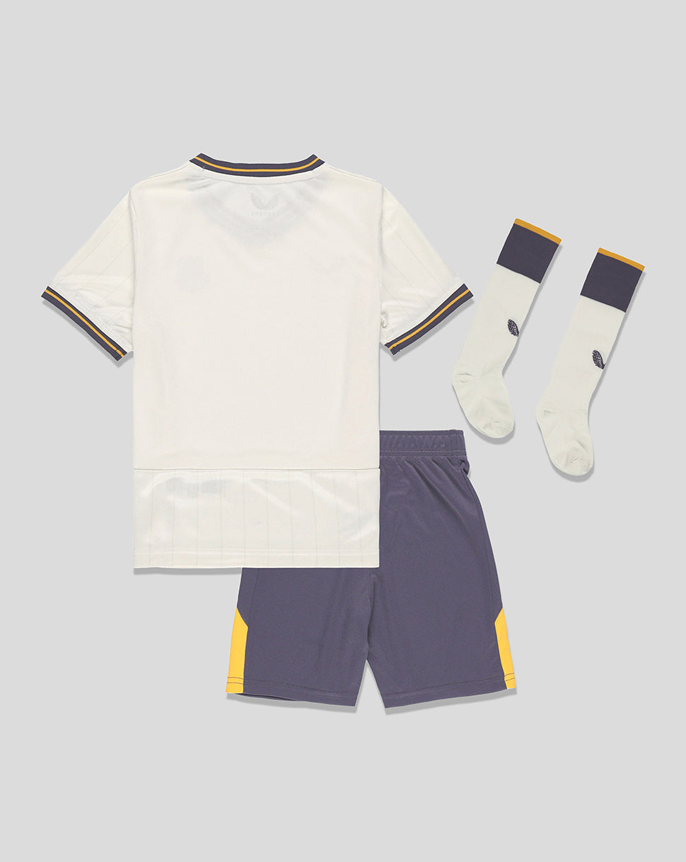 Everton 24/25 third infant kit laid flat showing white jersey with navy and gold trim, purple shorts, and matching socks