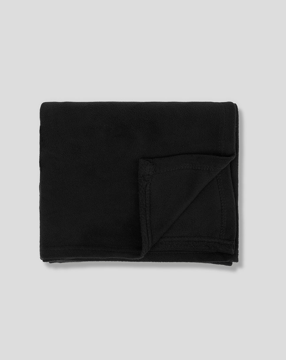 Black Silverstone fleece blanket folded neatly with corner visible and tag