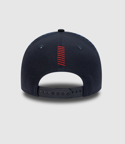 Back view of navy cap with red stitched center seam and adjustable strap