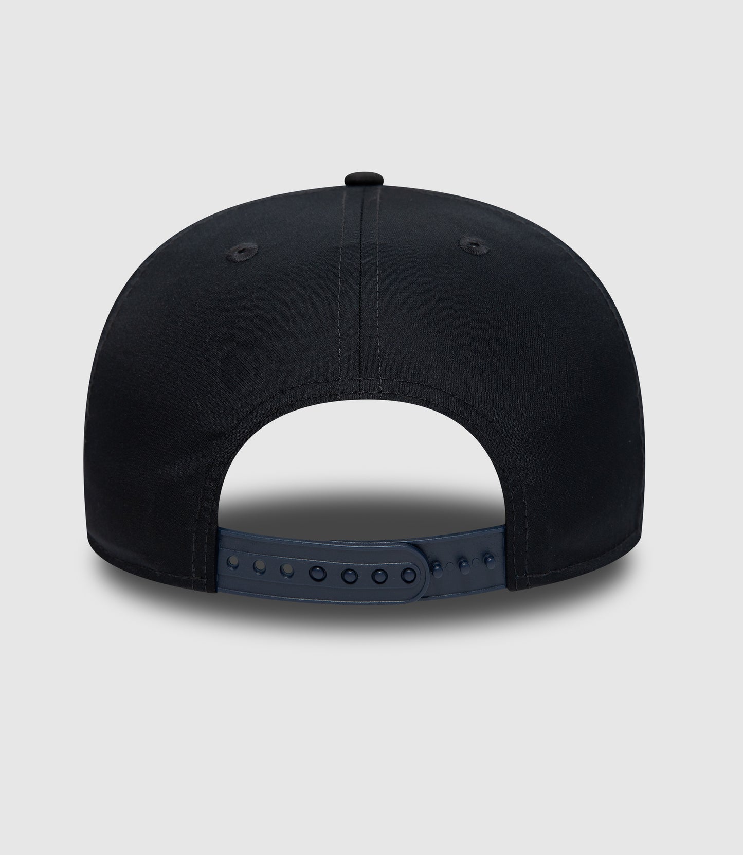Close up of navy cap crown with stitched panels and a small top button