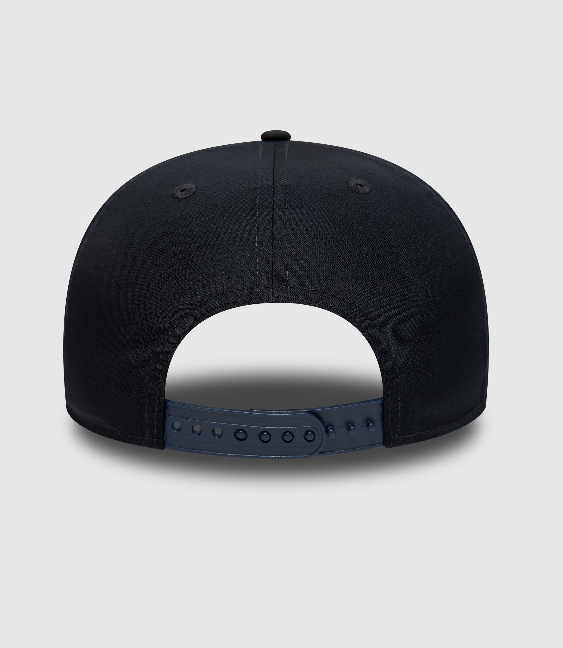 Close up of navy cap crown with stitched panels and a small top button