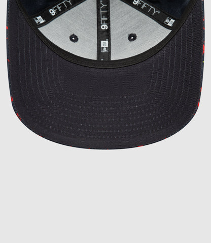 Interior view of navy New Era 9FIFTY snapback showing branded tape and adjustable rear strap