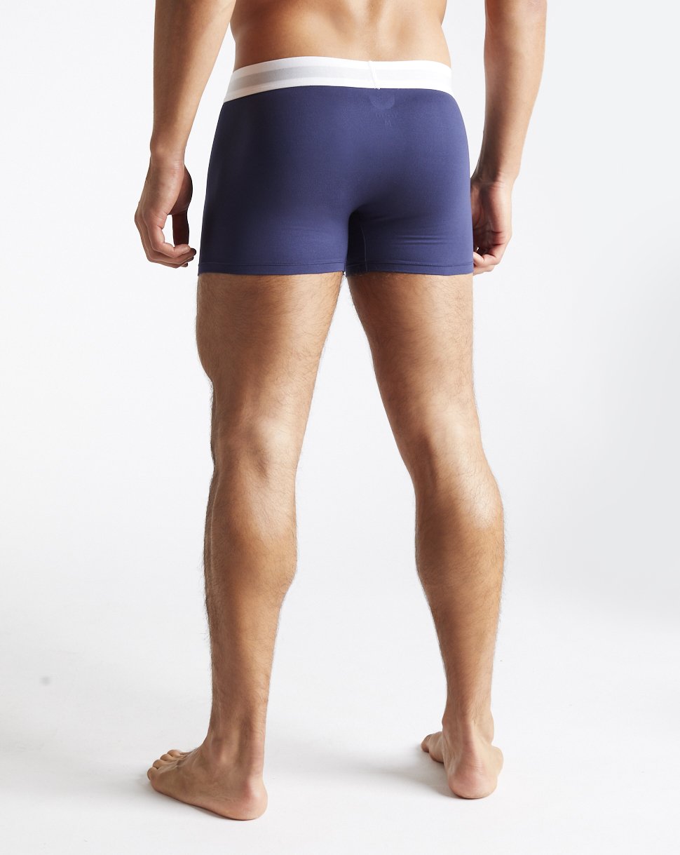 Rear view of a male model in navy Peacoat Boxer Shorts with a white CASTORE waistband