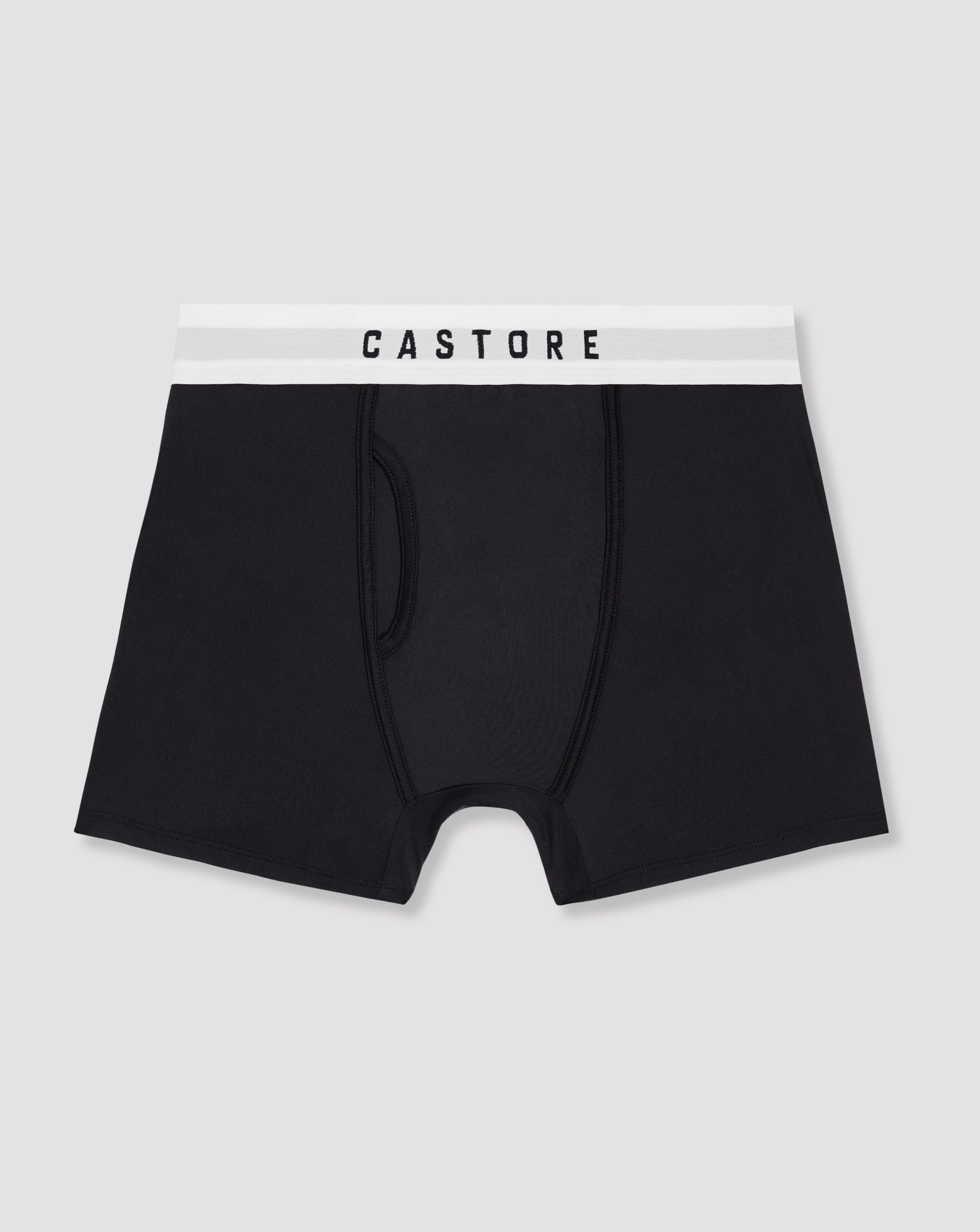 Close up of navy boxer shorts with a white CASTORE waistband shown in a stacked three pack