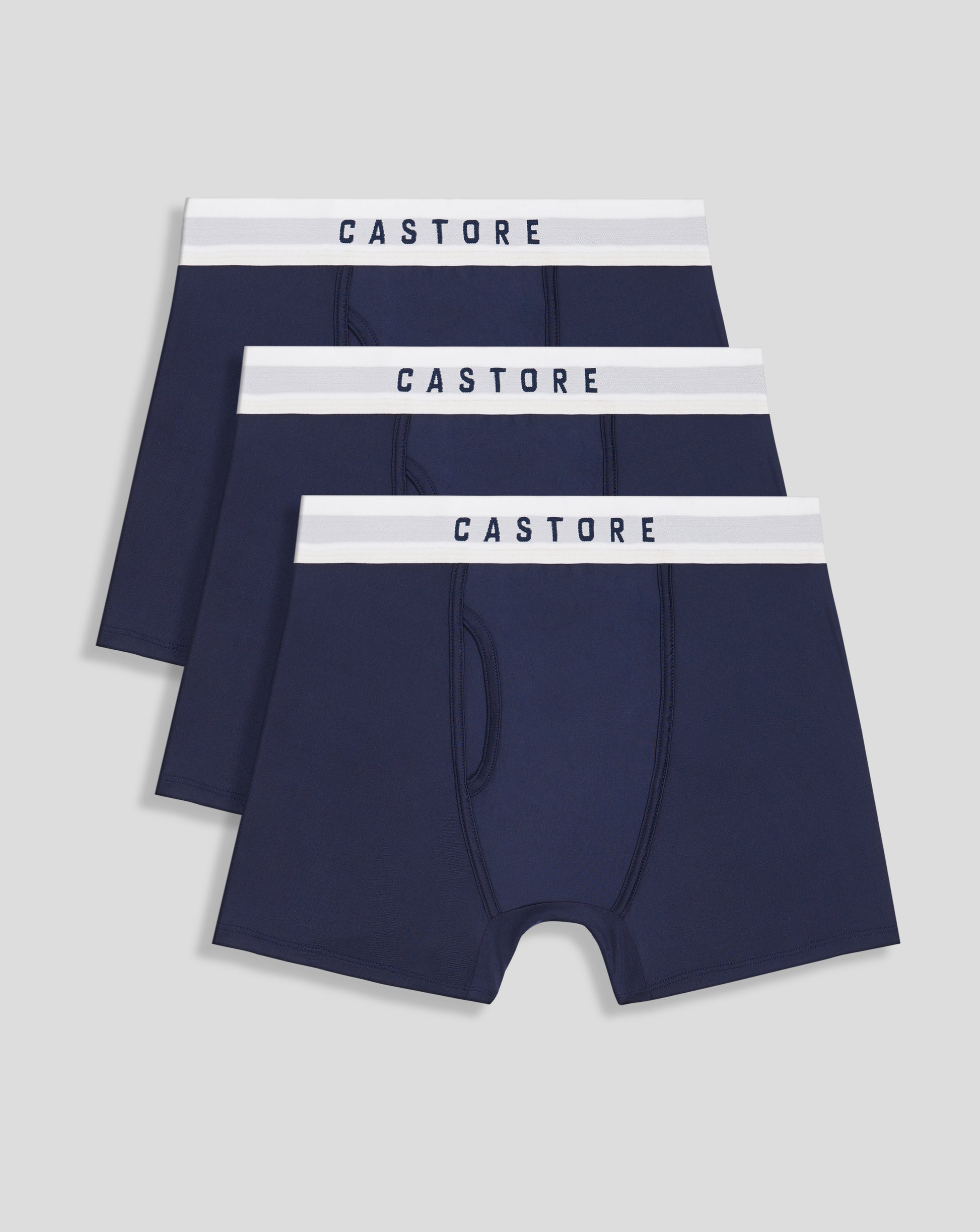 Close up of dark navy Peacoat boxer shorts with a white CASTORE waistband branding in a stacked arrangement